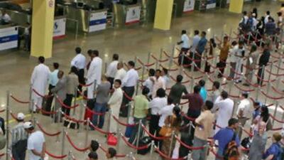 People line up for passport control in arrivals at the Dubai International Airport.