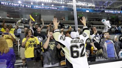 Carl Hagelin #62 of the Pittsburgh Penguins celebrates with fans after their 3-1 victory to win the Stanley Cup against the San Jose Sharks in Game Six of the 2016 NHL Stanley Cup Final at SAP Center on June 12, 2016 in San Jose, California. Bruce Bennett/Getty Images