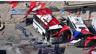 Turkish riot police buses are seen at the scene after an explosion close to the spot in Taksim Square.
