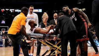epa03208975 The Knicks' Baron Davis is taken off the court on a stretcher after dislocating his patella during the third quarter of game four of the Eastern Conference quarterfinal game between the Miami Heat and the New York Knicks at Madison Square Garden in New York, New York, USA, 06 May 2012. The Knicks won the game and the Heat lead the series, 3-1. EPA/JUSTIN LANE Corbis Out *** Local Caption *** 03208975.jpg