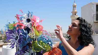 She collects and repurposes trash to create art — often collages themed on women's faces, flowers and Oriental motifs.