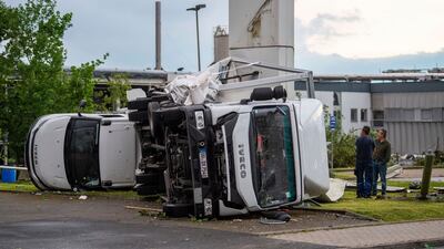 Two trucks were overturned in the storm. AP Photo