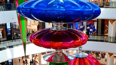 Hanging Christmas decorations at The Dubai Mall. Pawan Singh / The National