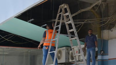 Workers fixing the damage at Abha airport. AFP