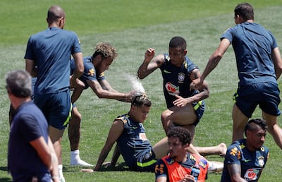 Brazil players throw flour and eggs on the head of teammate Philippe Coutinho to jokingly celebrate his birthday. AP