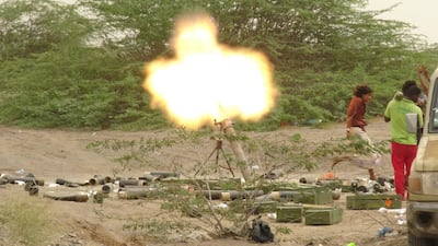 Yemeni pro-government forces fire a mortar round in Al Fazah in Hodeidah province on June 15, 2018. AFP