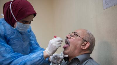A doctor takes a sample for a Covid-19 test at the Central Public Health Laboratories in Cairo, Egypt. EPA