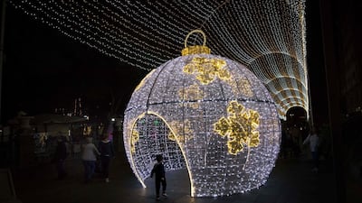 A kid plays under the Christmas lights adorning the streets of Santa Cruz de Tenerife in Tenerife. AFP