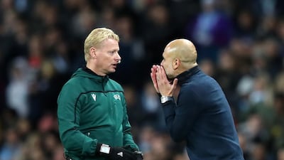 Manchester City manager Pep Guardiola talks to fourth official Kevin Bloom. Getty Images