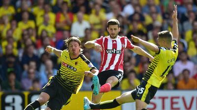 Watford's Sebastian Prodl, left, tackles Southampton's Shane Long during their Premier League contest on Sunday. Leon Neal / AFP