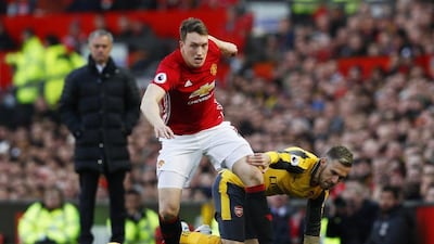 Manchester United's Phil Jones in action with Arsenal's Aaron Ramsey. Jason Cairnduff / Reuters