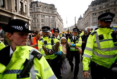 Police officers detain a climate change activist at Oxford Circus during the Extinction Rebellion protest in April. Reuters