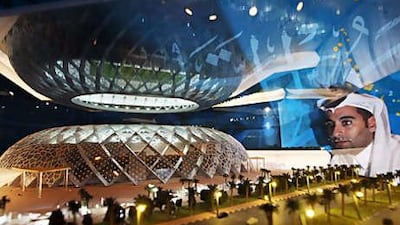 A visitor admires a model of one of the new stadiums to be built in Qatar for their 2022 World Cup bid at the unveiling of their designs in Dubai last month.
