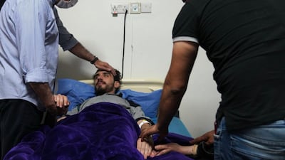 Iraqi Prime Minister Mustafa Al Kadhimi visits activist Ali Al Mikdam in hospital in Baghdad. Iraqi PMO Twitter