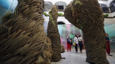 People look at Kokon's 'Ovidio' installation by Mari Eugenia de Diego, dislayed as part of the International Flower Festival 'Flora 2022', showing avant-garde creations with natural flowers in Cordoba, Spain. The installation won first prize at the festival. EPA