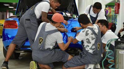 Staff working on a car at FoilX in Dubai. Courtesy Zine Arabia / zinearabia.com