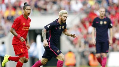 Liverpool forward Roberto Firmino in action against Lionel Messi. John Sibley / Reuters