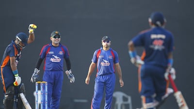 Pakistan's Kamran Akmal playing wicketkeeper for Grand Midwest, with teammate Taufeeq Umar during the Bukhatir Cricket League semi-finals on Thursday in Sharjah. Jeffrey E Biteng / The National / June 26, 2014