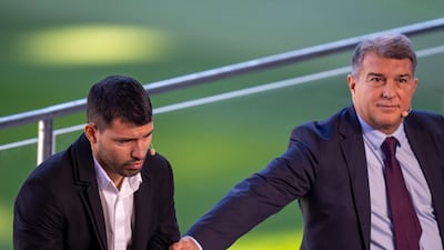 Sergio Aguero is comforted by Barcelona president Joan Laporta. AP