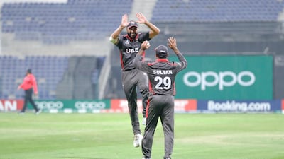Abu Dhabi, United Arab Emirates, October 27, 2019. T20 UAE v Canada-AUH- -- (R-L) Rameez Shahzad gives a jumping high five to Sultan Ahmad during their match against Canada. Victor Besa/The National Section: SP Reporter: Paul Radley