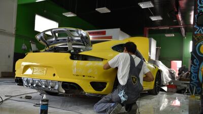 Staff working on a car at FoilX in Dubai. Courtesy Zine Arabia / zinearabia.com