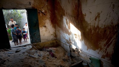 Palestinians inspect the damaged house hit by Israeli airstrikes that killed 23-year-old pregnant mother Enas Khammash and her 18 month-old daughter Bayan. AP Photo