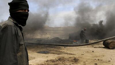 Men work at a makeshift oil refinery site in the Kurdish town of al-Qahtaniya. Rodi Said / Reuters