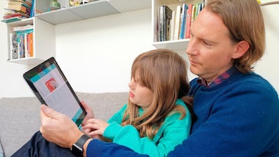 Paddy Kelly and his daughter use gohenry, a digital banking apps for children. A wave of digital pocket money apps that come with prepaid cards are new tools for financial education as money increasingly goes digital. Photo: AP