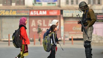 Kashmiri residents walk past Indian troopers standing guard during curfew and restrictions in downtown Srinagar as the unrest in Kashmir entered its 126th day on November 11, 2016. More than 90 civilians have been killed and thousands injured during the latest protests against Indian rule, sparked by the killing on July 8 of a popular rebel leader of Hizbul Mujahieed during a gunfight with Indian soldiers. Kashmir has been divided between India and Pakistan since their independence from British rule in 1947. Both claim the territory in full. Tauseef Mustafa / Agence France-Presse