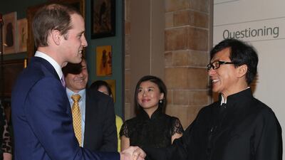 Prince William meets actor Jackie Chan during a reception for the Illegal Wildlife Trade conference at the Natural History Museum in London on February 12, 2014. AFP
