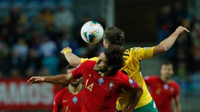 Portugal's Goncalo Paciencia, left, vies for the ball with Lithuania's Saulius Mikoliunas. AP