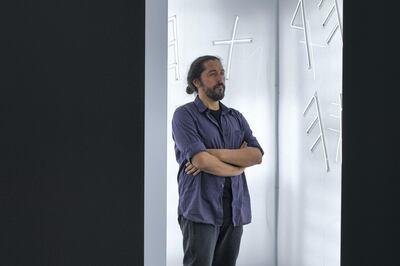 A visitor takes in Sarah Alagroobi’s installation ‘The Sun Never Sets on the Empire'. Khushnum Bhandari for The National