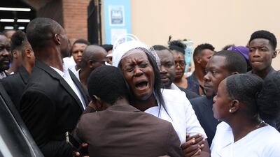 Eunide Majeur Montis, the wife of mission director Judes Montis, cries after attending his funeral service in Port-au-Prince, Haiti. AP