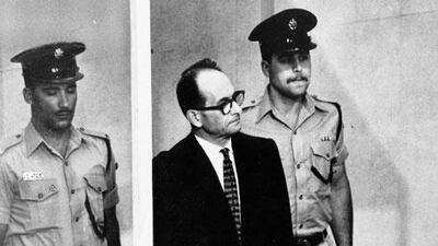 Adolf Eichmann at his trial in a bullet-proof booth.