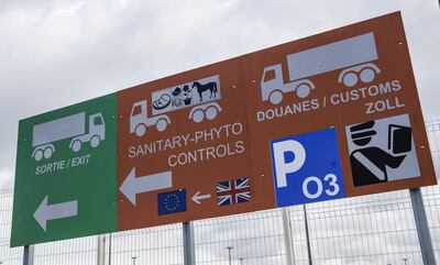 A new 'orange zone' sign for UK livestock, food cargo and passenger customs checks with a 'green zone' traffic sign sits on display in a parking lot at the Port of Calais. Bloomberg