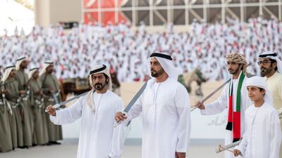 Sheikh Hamdan bin Mansour; Lt Gen Sheikh Saif bin Zayed Al Nahyan, Deputy Prime Minister and Minister of Interior; and Sheikh Khalifa bin Tahnoun, Executive Director of the Martyrs' Families' Affairs Office, participate in a traditional ayyala. Mohamed Al Hammadi / Presidential Court