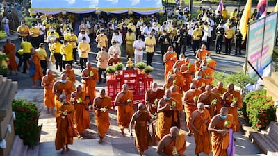 Buddhist monks hold candles and flowers as they lead devotees around giant Buddha statue to mark Asalha Bucha Day in Thailand's southern province of Narathiwat amid Covid-19 restrictions. AFP