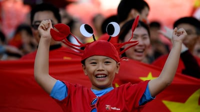 A China supporter cheers ahead of the 2019 AFC Asian Cup group C football match between Philippines and China at the Mohammed Bin Zayed Stadium in Abu Dhabi. AFP