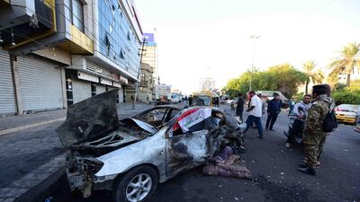 Iraqis inspect the site of a car bomb attack near Al Tahrir square in central Baghdad, Iraq. EPA