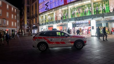 A police car in the area where a stabbing occurred in the department store, in Lugano, Switzerland. AP