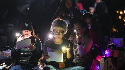 Abu Dhabi, United Arab Emirates - The singing of Christmas carols by candlelight started after dark in the desert. Khushnum Bhandari for The National