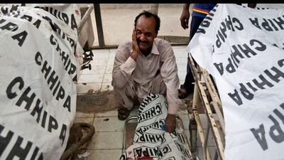 The father of a Pakistani policeman, who was killed in a bomb blast, mourns next to the body of his son at a hospital in Karachi, Pakistan. Shakil Adil / AP Photo