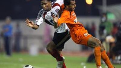Subait Khater, left, races past an Ajman defender during his side's 4-1 victory on Sunday night.