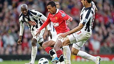 Nani, the Manchester United winger, dribbles his way past West Bromwich Albion’s Paul Scharner as United threw away a two-goal lead against the visitors yesterday.