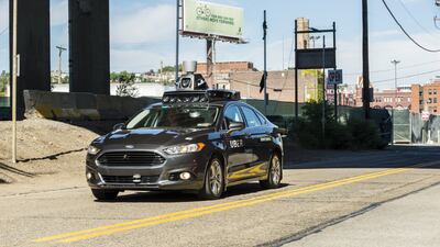 A passenger looks on as an Uber self-driving car taks to the roads in Pittsburgh, Pennsylvania. Intel plans to take the lead in the autonomous vehicle sector with the purchase of Mobileye. Angelo Merendino / AFP
