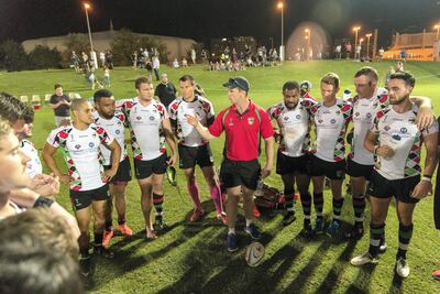Members of the Abu Dhabi Harlequins gather in a huddle after defeating the Dubai Exiles 29-25 at Zayed Sports City in Abu Dhabi on Friday night. The players were informed the following morning that their teammate Garth van Niekerk had passes away in South Africa. Christopher Pike / The National
