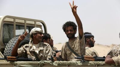 A soldier gestures as he rides in the back of a pick-up truck accompanying Gulf Arab soldiers arriving in Yemen's northern province of Marib on September 8. Reuters