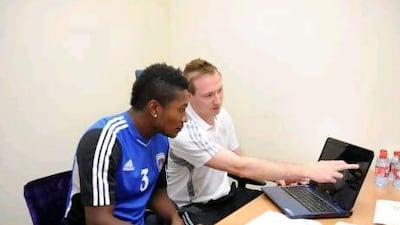 Liam Weeks, above right, the performance analyst for Al Ain, works with players, such as Asamoah Gyan to help improve their play.