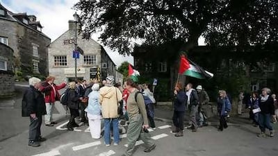 Hikers gather to participate in a walk for the Palestine Solidarity Campaign in Derbyshire, England.