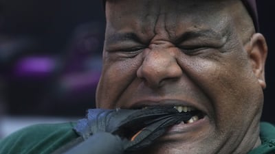 Egyptian wrestler Ashraf Mahrous, also known as Kabonga, pulls a heavy weight with his teeth during a training session at his gym in Cairo, Egypt, Tuesday, July 15, 2025. (AP Photo / Amr Nabil)